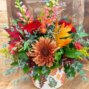 Autumn Leaves fall flower arrangement with bronze mums, red gerbera daisies, snapdragons and colorful fall foliage