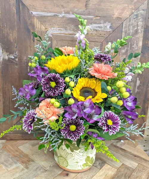 Fall garden flower arrangement with sunflowers, purple mums, peach carnations, alstroemeria, berries, and greenery, available for local delivery in Gilbertsville, PA.