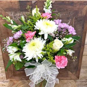 Soft pastel flower arrangement with white chrysanthemums and pink flowers in a glass vase – Gilbertsville PA florist
