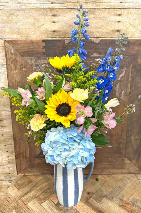 Sunflower and blue hydrangea flower arrangement in a striped container – Gilbertsville PA florist